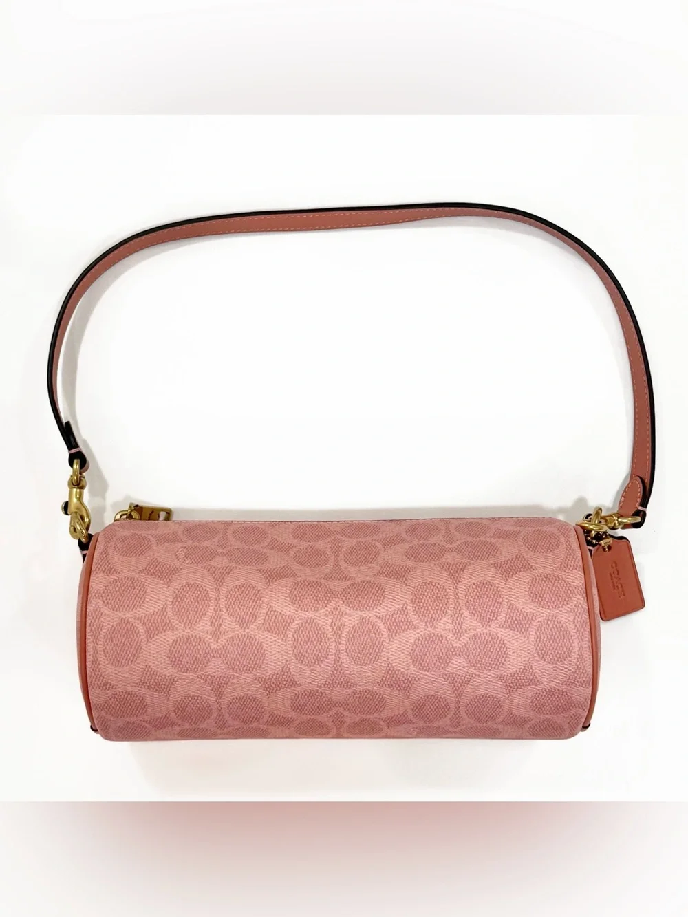 New Coach cylinder barrel bag in melon pink/ brass with signature canvas